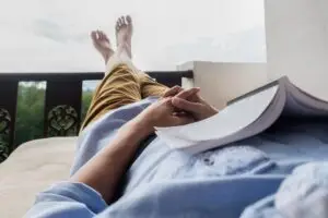 man relaxing on his balcony after a long day for his mental health