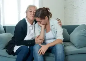 mother and daughter having an intervention on the couch in their living room - mental health intervention