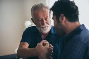 dad and son addressing the sons mental health in their home