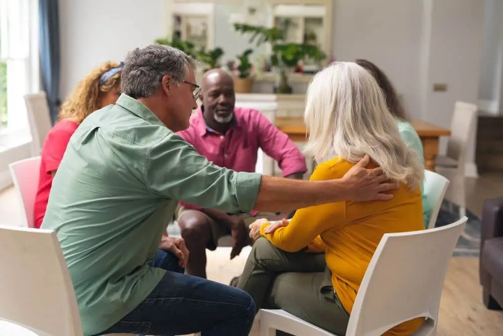 A group participating in collaborative therapy to support one another.