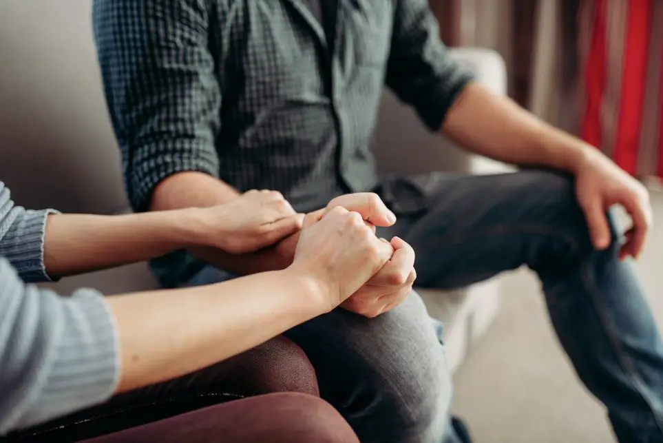 A woman showing support towards family member while in therapy.