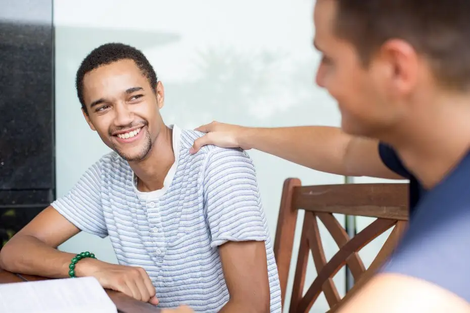 A young man consoling his friend to show his support and empathy.