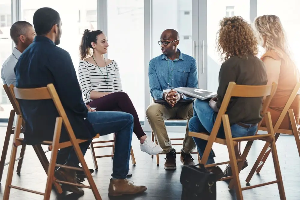 A group of healthcare professionals discussing treatment plans for their mental health patients.