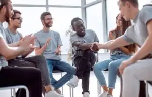 A rehabilitation group congratulating each other on their individual successes.