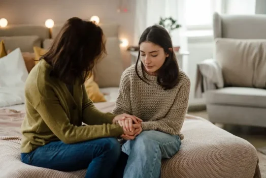 A mother having open dialogue with her teenage daughter to discuss her child's emotional state.