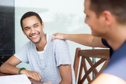 A young man consoling his friend to show his support and empathy.