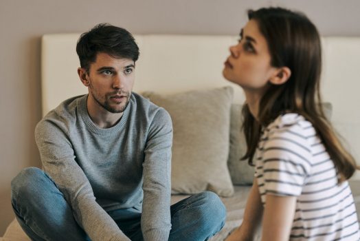 woman experiencing a bipolar episode trying to talk to her partner on the couch